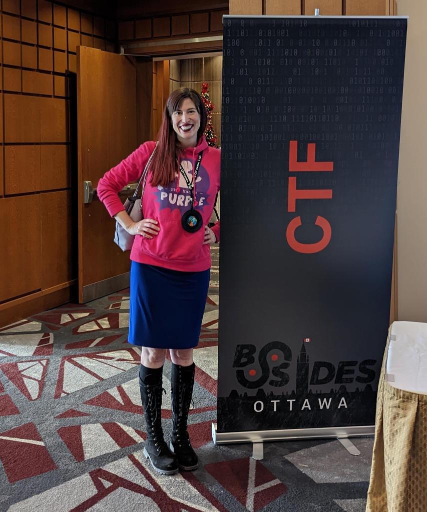 Tanya Janca standing next to a large sign that says "CTF" at B-Sides Ottawa, November 2022.